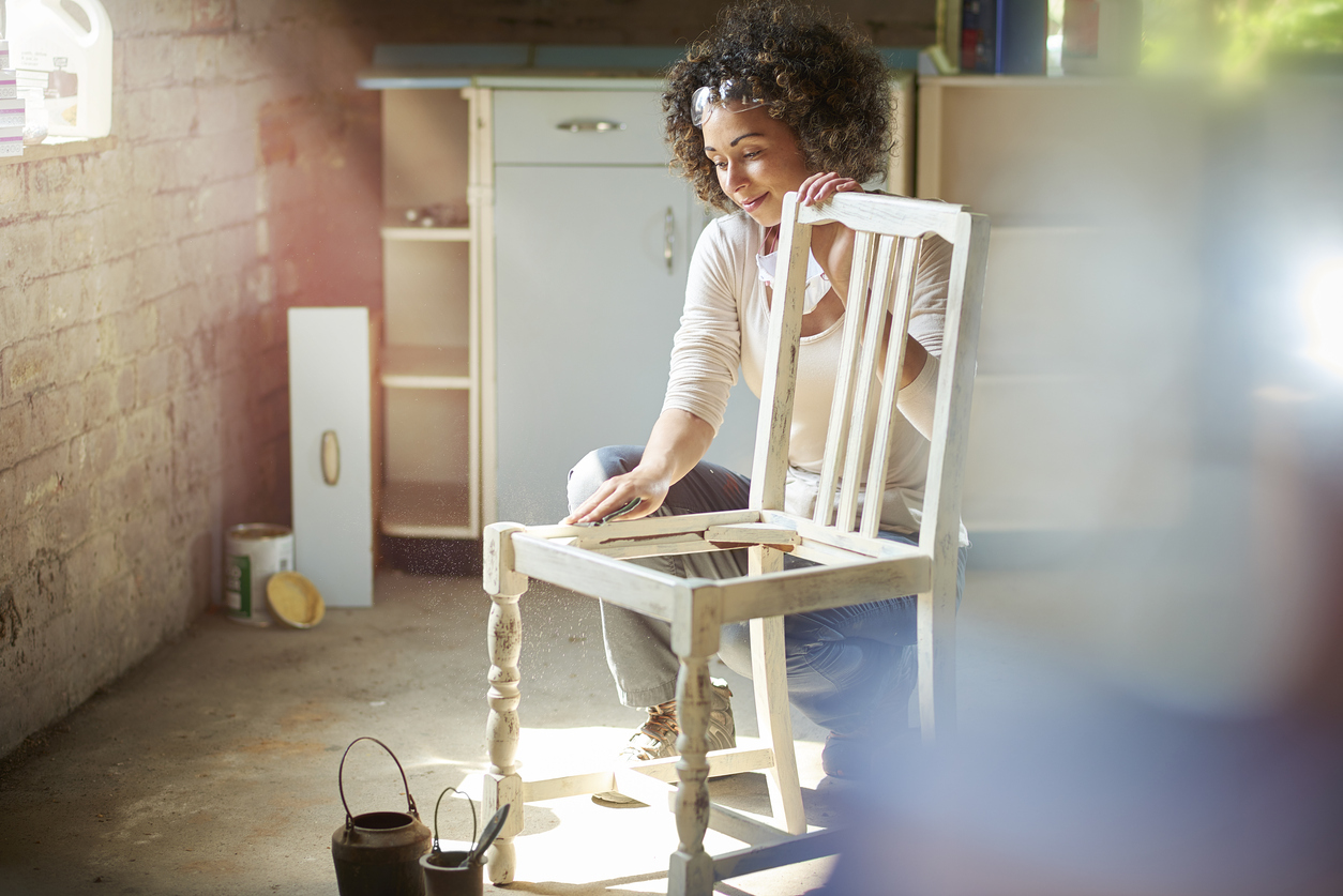 iStock Credit: sturti woman restores and improves an old wooden chair in her workshop