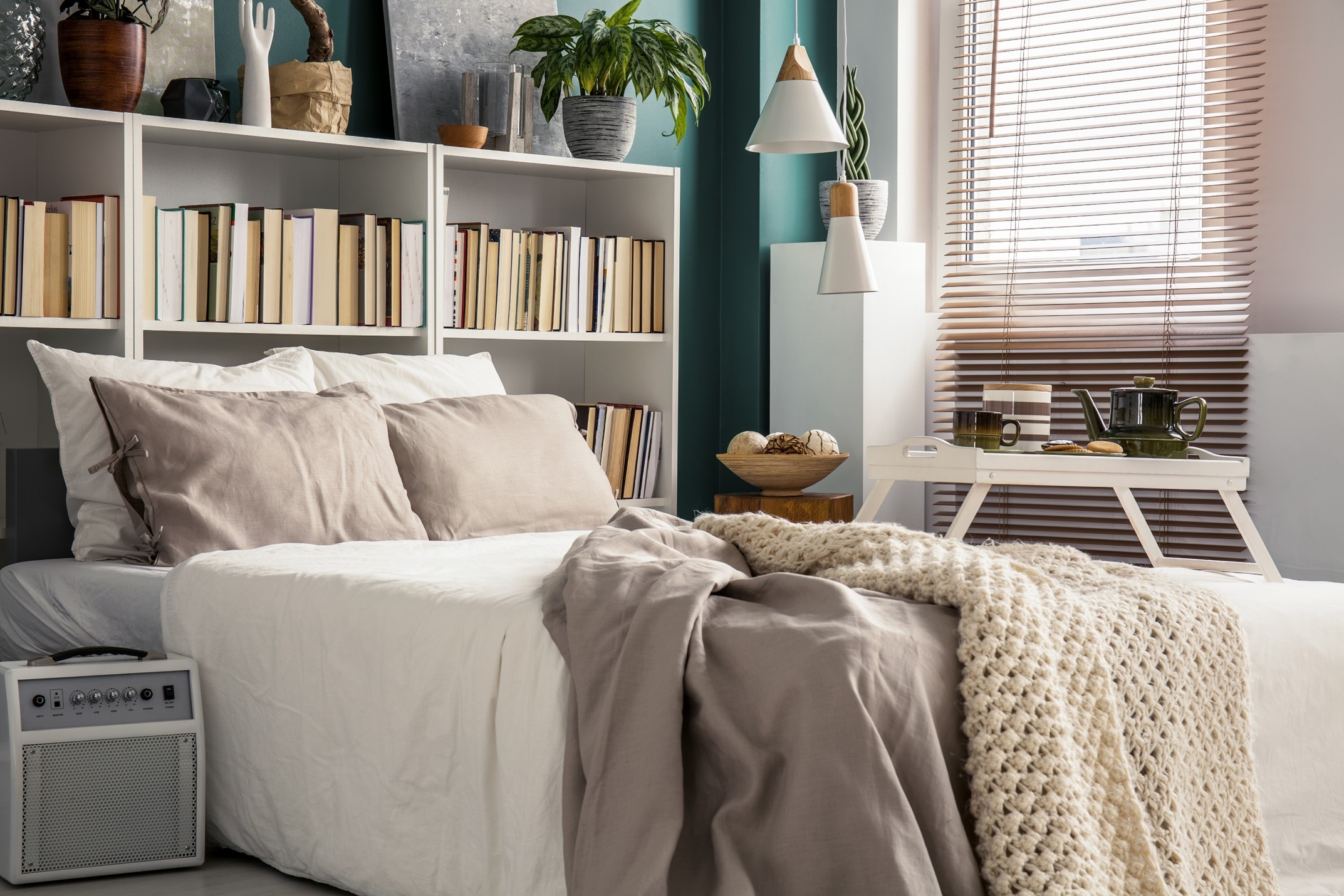A bed with a bookcase headboard 