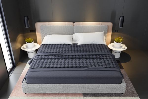 Overhead view of a king size mattress with gray decor