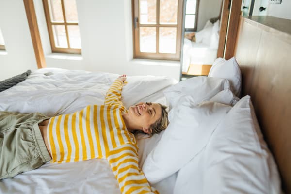 A smiling woman on a mattress