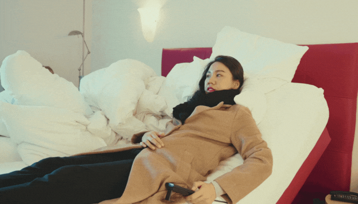 Woman adjusting her side of the bed