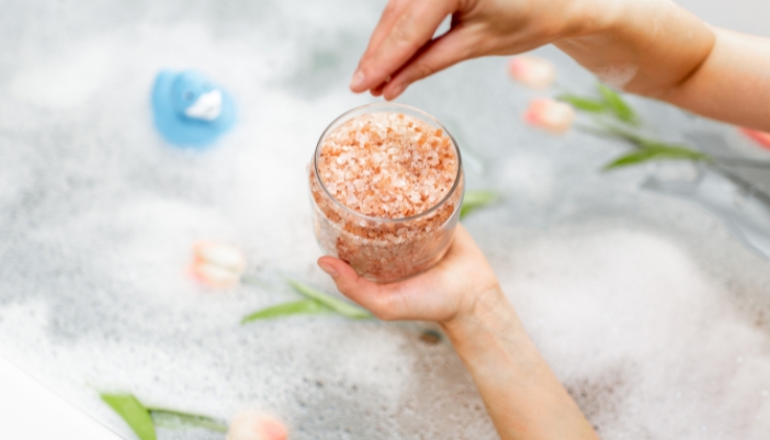 Matt_DIY-Aromatherapy-Solutions_5.jpg Closeup of someone adding homemade bath salts to their bath