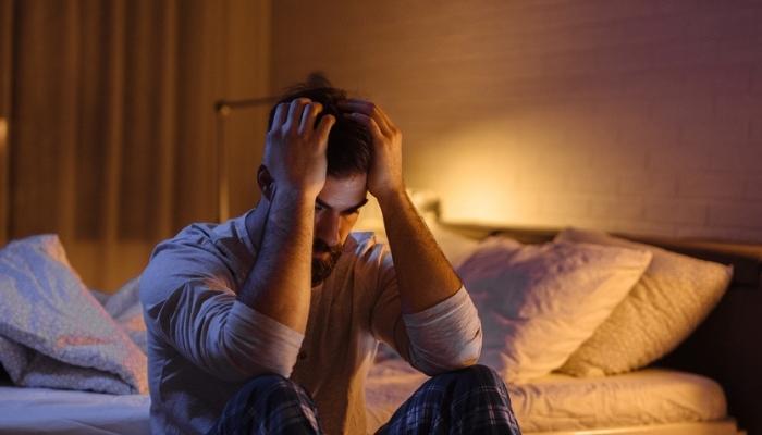 man frustrated due to lack of sleep