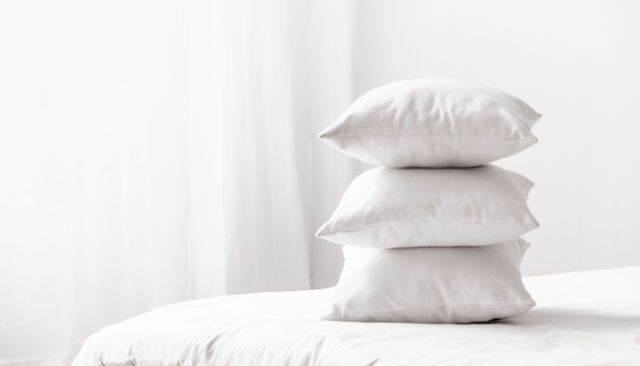 Matt_Find-Dream-Pillows_1.jpg A stack of pillows on top of a bed