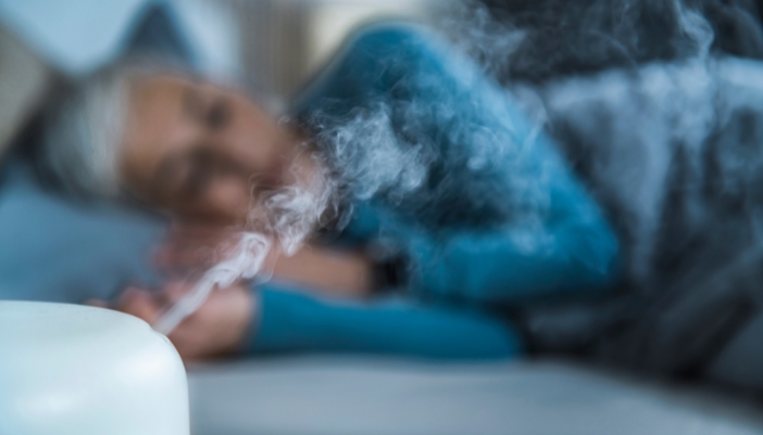 Matt_Sleep-Apnea-Bedding-Solutions_4.jpg Woman sleeping with a humidifier in the room