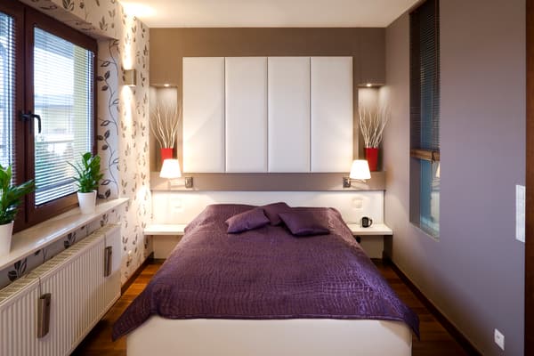 iStock Credit: alvar Wide shot of a full size bed in a small bedroom