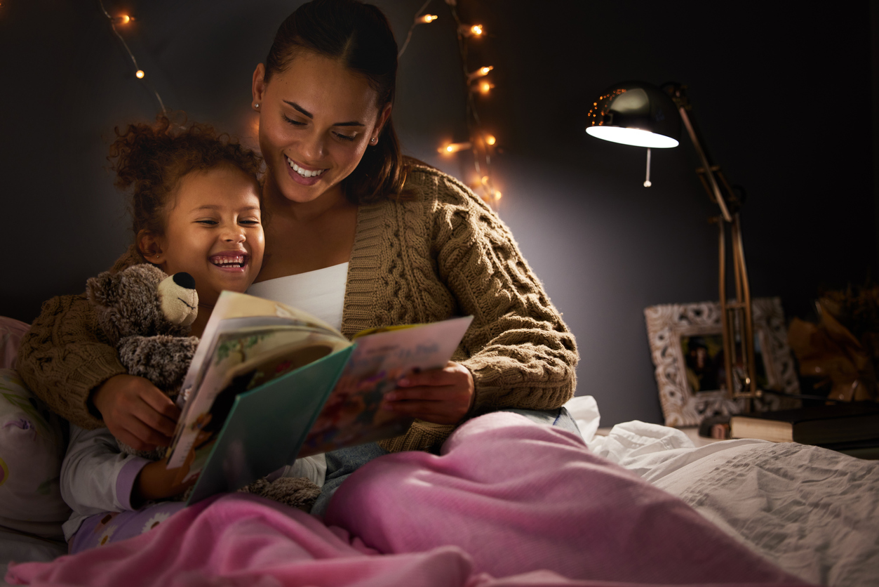 iStock Credit: PeopleImages young mother reading her daughter a bedtime story