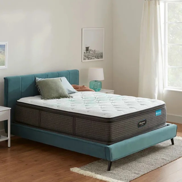 Smaller, modern bedroom with a Beauty rest Queen pillow top mattress.