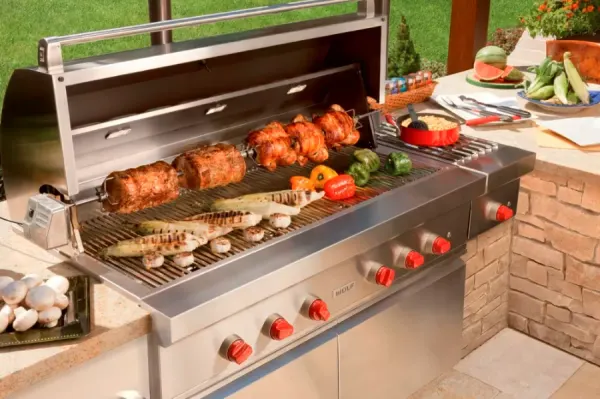 Credit: Wolf The Wolf OG54-LP 6-burner grill grilling various items