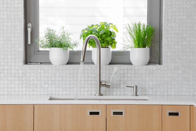 Front view of a modern sink with a single hole kitchen faucet Front view of a modern sink with a single hole kitchen faucet
