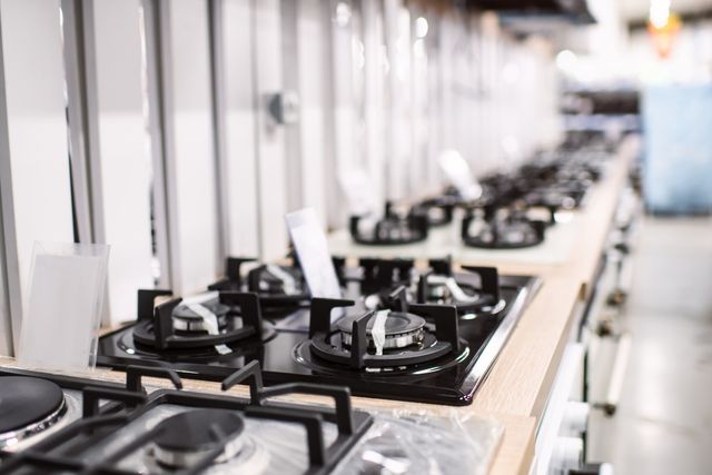 View of a line of stove tops in an appliance store