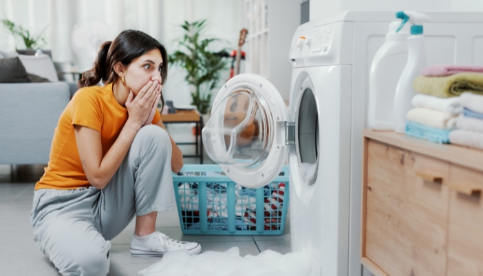 Woman horrified that her washer is leaking bubbles