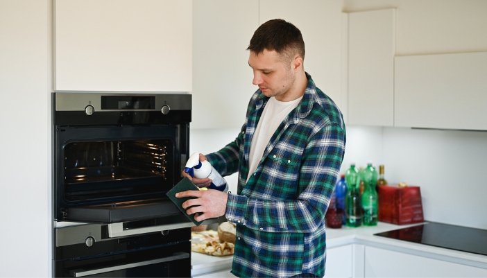 A man cleaning out his steam oven