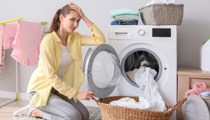 Serv_Washer-Dryer-Combo-Problems_1.jpg Woman frustrated with her damp clothes