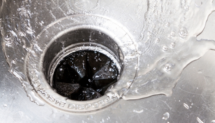 Closeup of water running down the garbage disposal