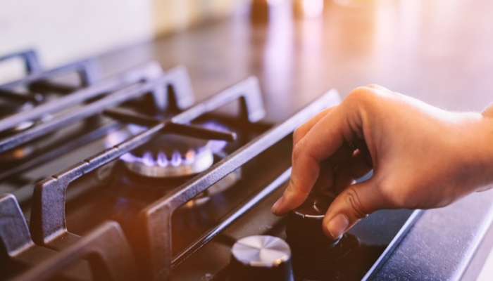 Closeup of someone turning on a burner