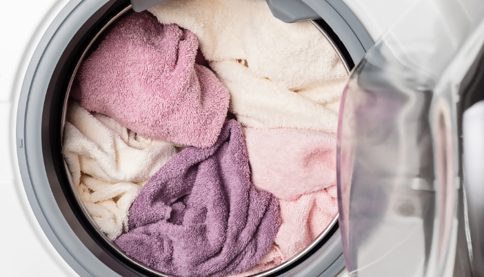 Closeup of a full washer loaded with thick towels