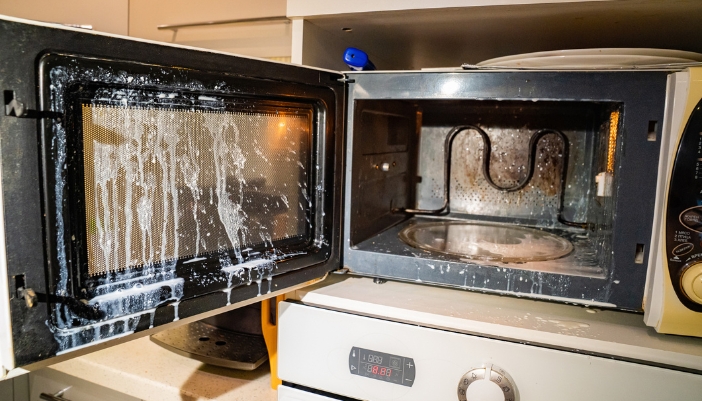 Serv_Repair-vs-Replace-Microwave_4.jpg Closeup of a burnt-out microwave