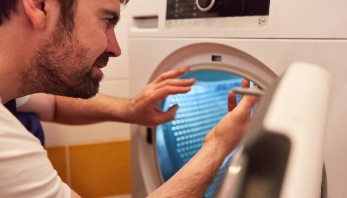 Appliance technician checking the dryer seals for mold buildup