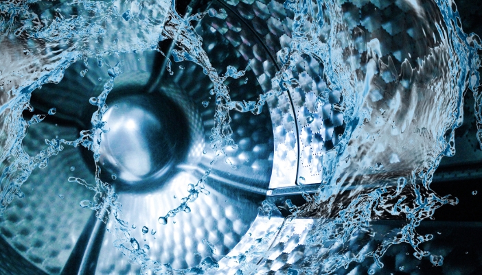 Concept image of hard water circulating a washer drum