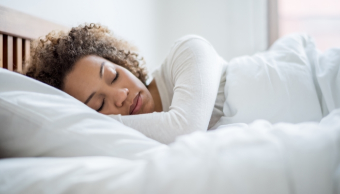 A woman sleeping peacefully on a new mattress