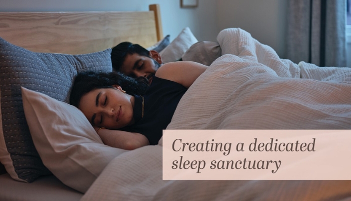 A man and woman sleep soundly in their bed at home.