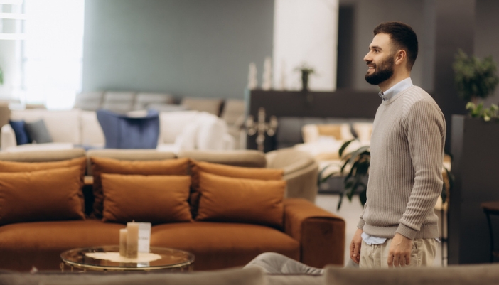 A man walks into a furniture showroom.