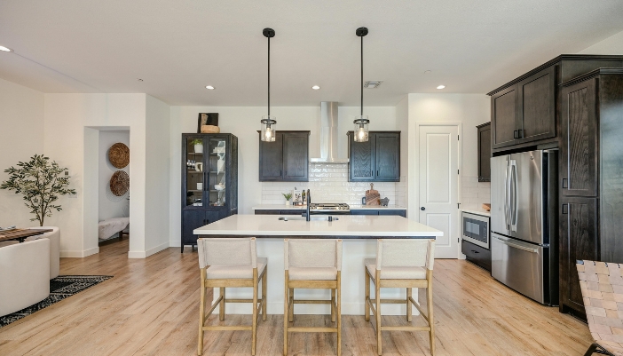 An eye level view of a modern kitchen with stainless steel appliances.