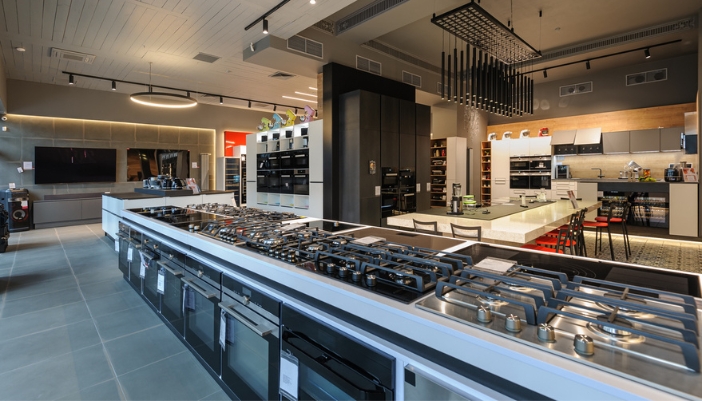 An appliance showroom with no people and a selection of ranges and refrigeration.