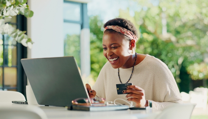 A woman shops online at home on her laptop.