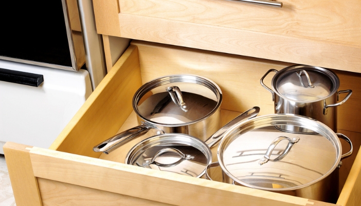 A kitchen with matching cabinetry, countertops, and appliance finishes