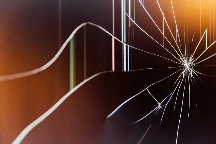 A close-up of a shattered TV screen.