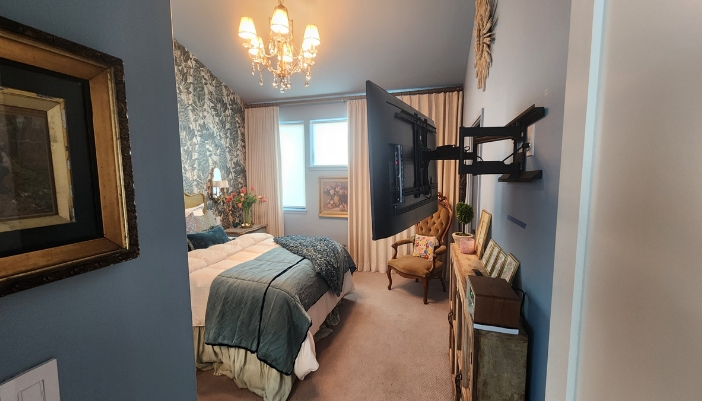 A tv mounted on the wall in a luxury modern bedroom.