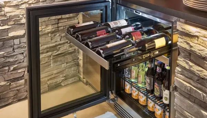 A close-up of a beverage center open with multiple bottles of wine.