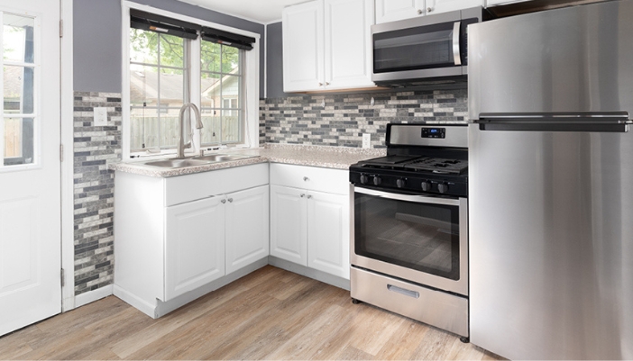 A compact, modern kitchen with stainless steel appliances.