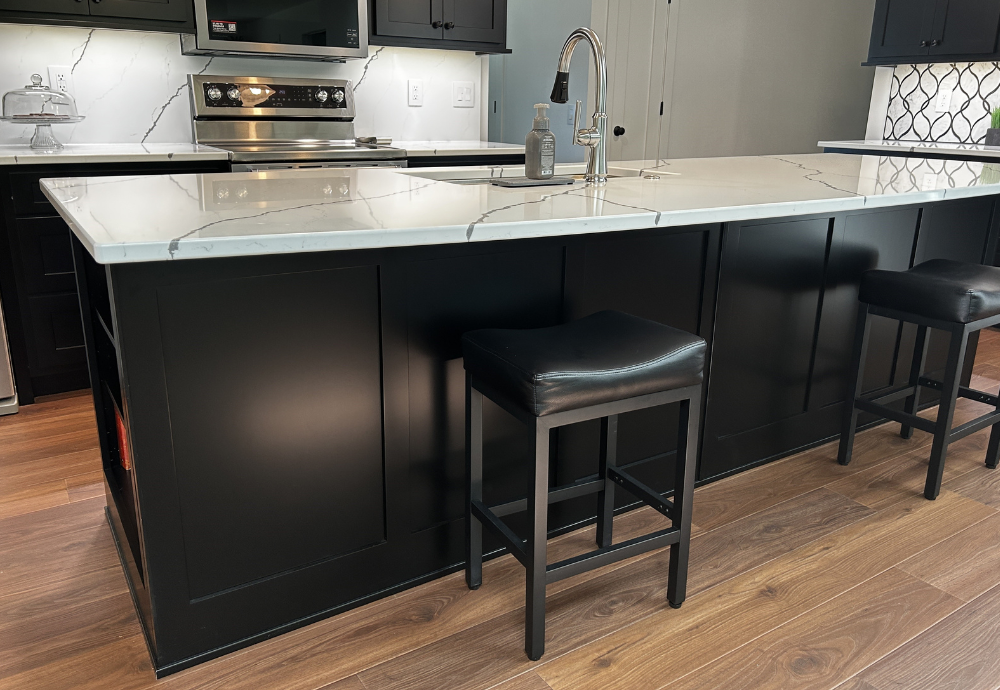 image of black painted kitchen island with wainscot paneled back treatment