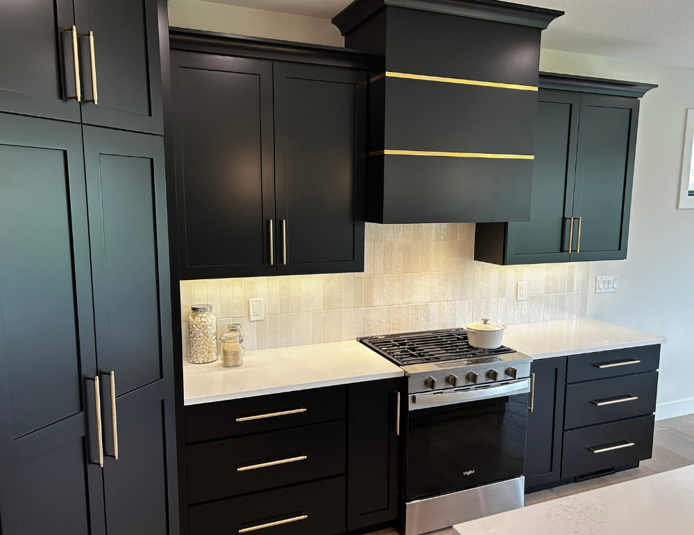 black cabinet kitchen design with range hood and metal bands