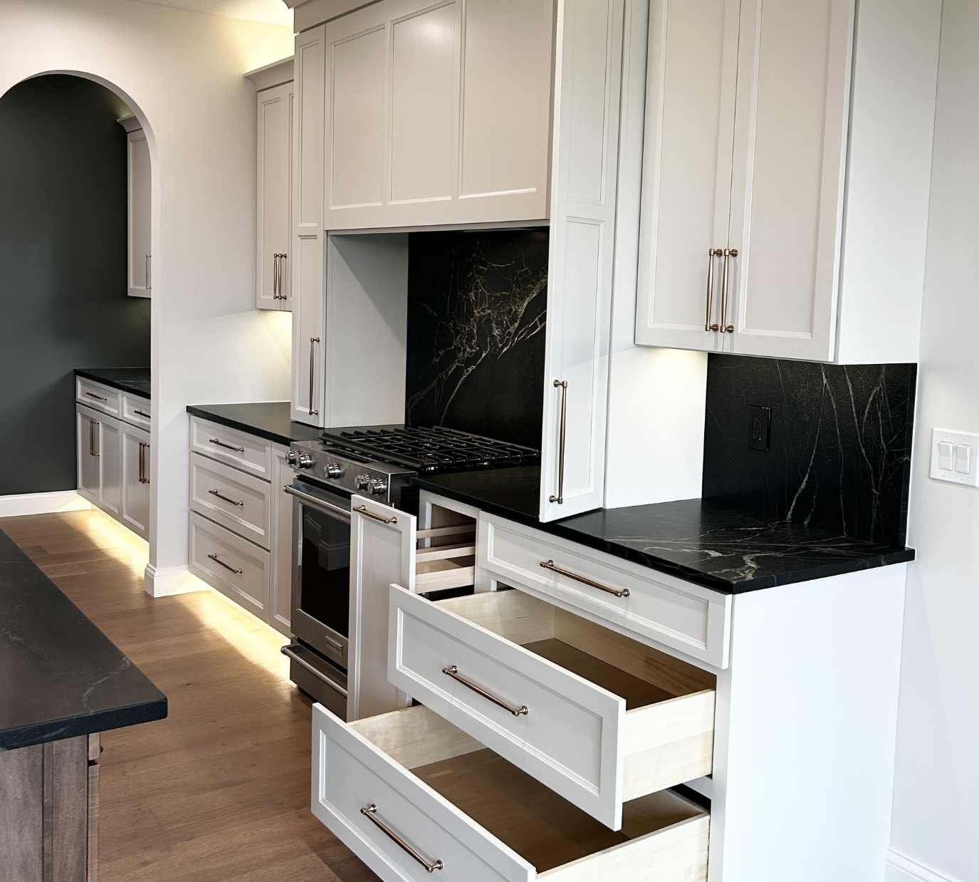 white cabinet kitchen with cookware storage in large drawers and pull out cabinets