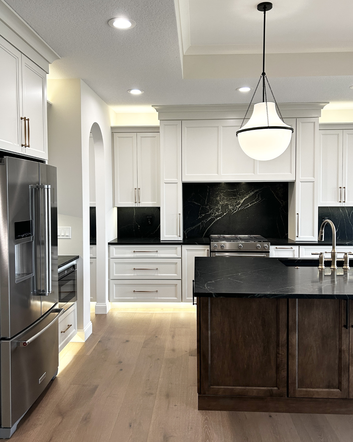 kitchen design in quad cities with white cabinets and medium maple island