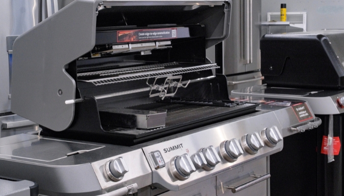A large open Summit grill with accessories featured.
