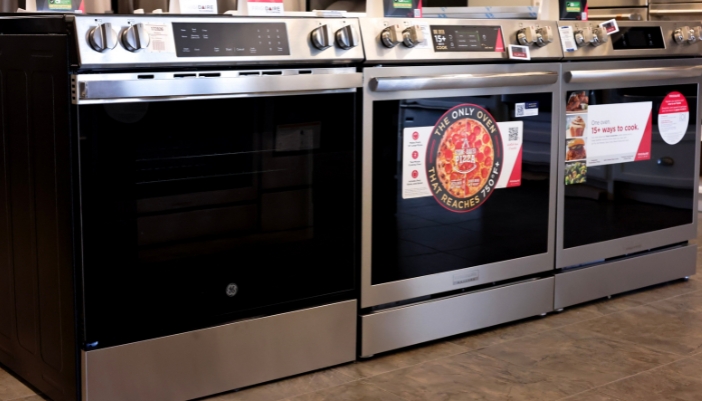 A selection of ranges in an appliance showroom.