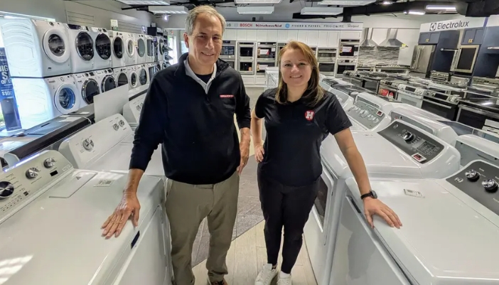 Two Hallocks employees stand in a showroom.