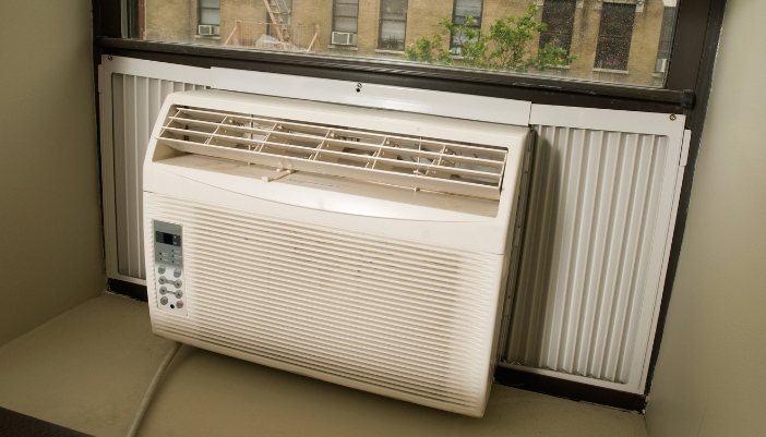 A close-up of a window unit air conditioner in a home.