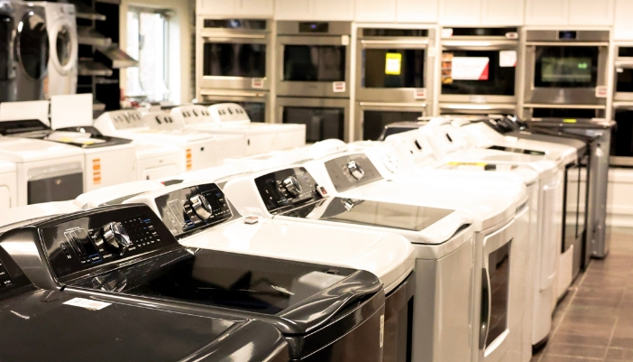 A variety of finishes on laundry appliances in a showroom.
