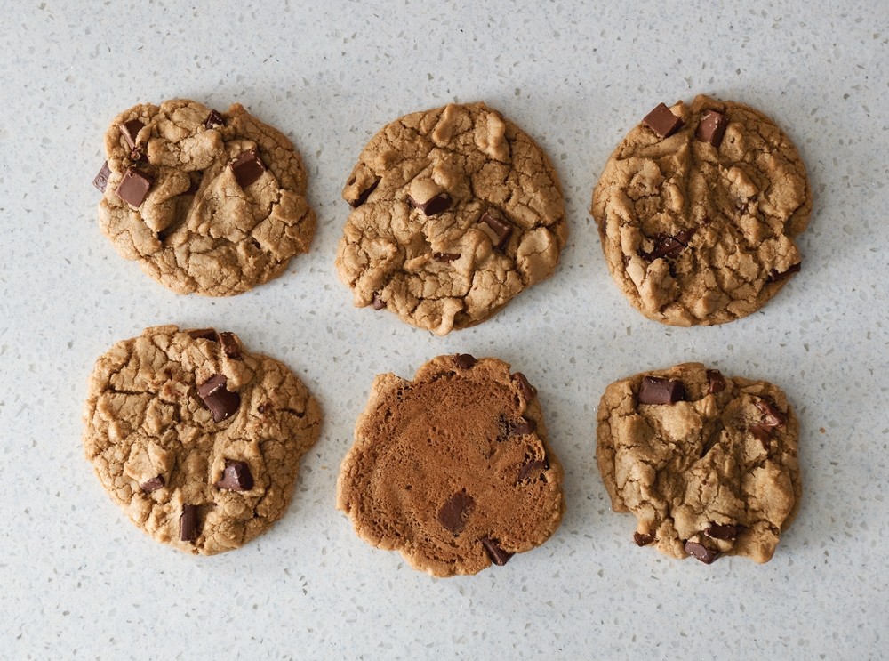 Six chocolate chip cookies demonstrating the even cooking results of a convection oven