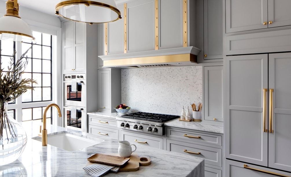 Long shot of Wolf rangetop, ventilation, and double wall oven, and Sub-Zero refrigerator in Baltimore Row kitchen design by Bria Hammel