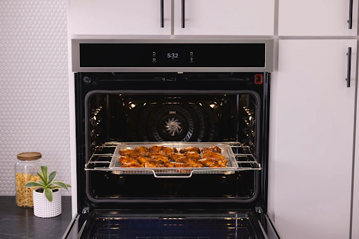 Chicken wings frying inside a Frigidaire wall oven 
