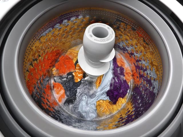 Open top load washer showing an agitator. Open top load washer showing an agitator.