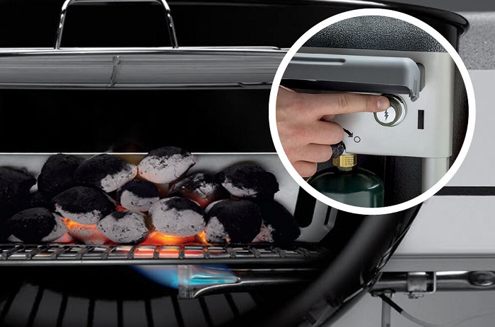 Person igniting Weber 15501001 charcoal grill with Touch-N-Go feature 