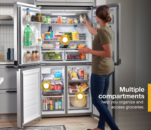 Woman getting food from a fully opened Whirlpool WRQA59CNKZ French door refrigerator 